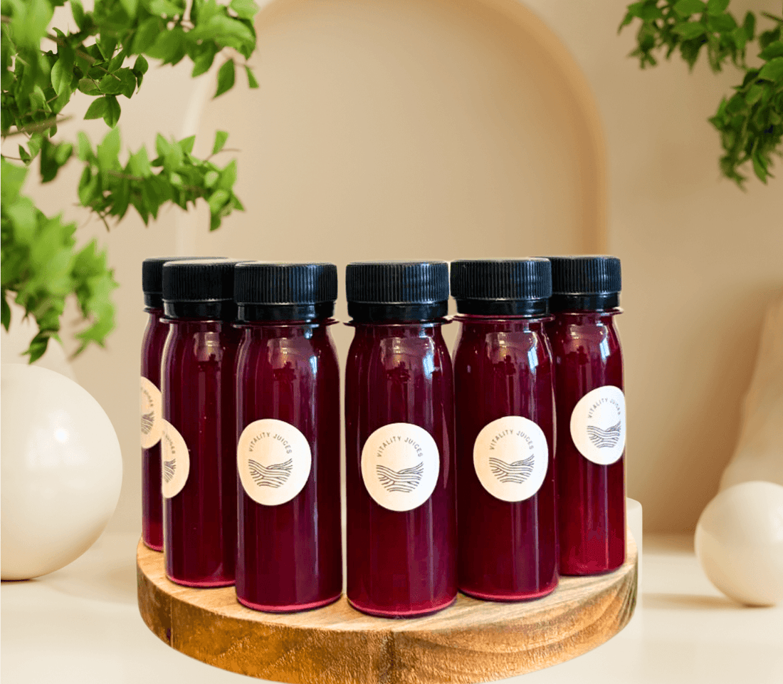 Vitality Sea Moss Beetroot Wellness Shots lined up on a wooden tray – natural colon detox and cleanse support